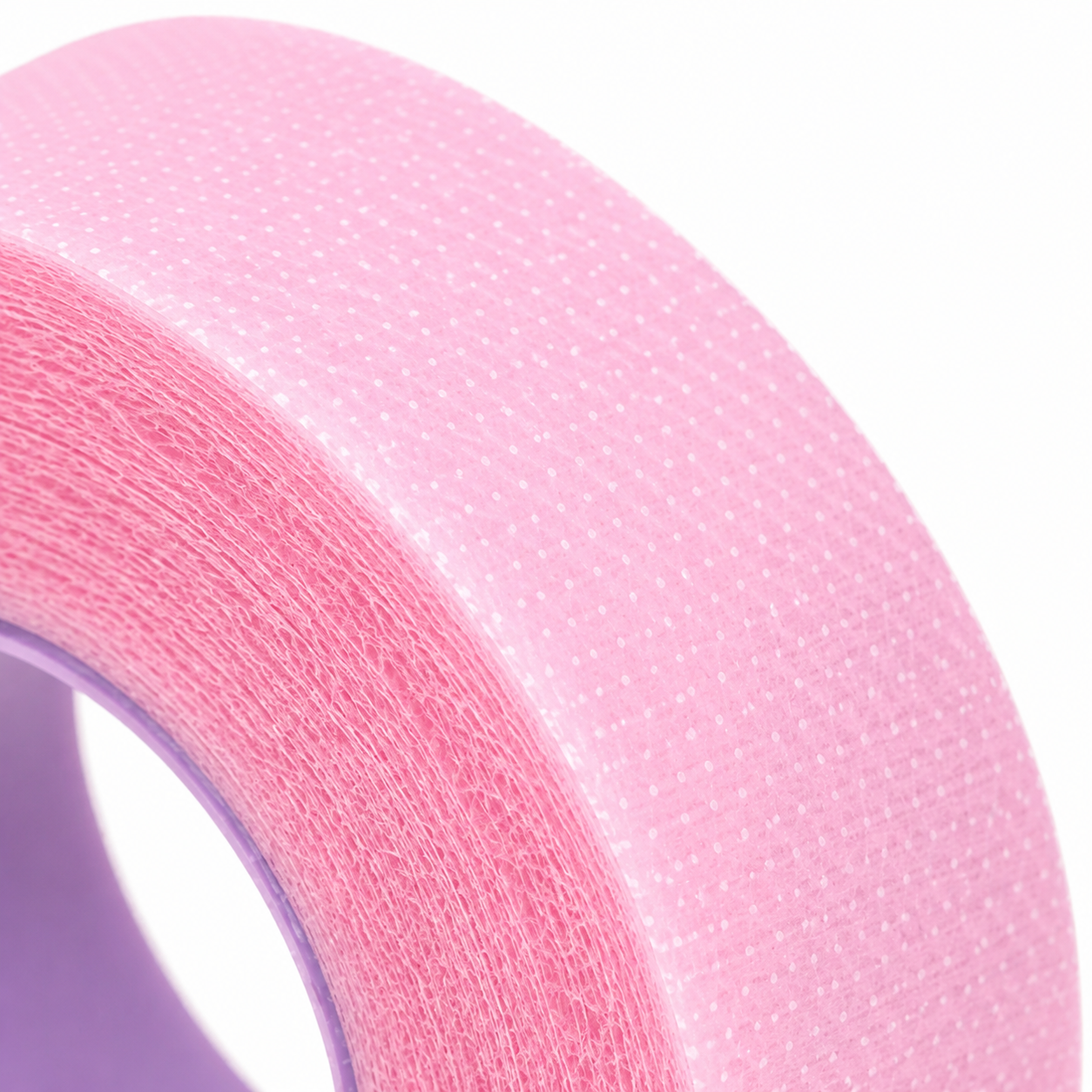 A roll of pink breathable micropore tape designed for lash extension procedures to hold lashes in place and support clean lash application