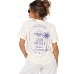 Back view of a model wearing a white Thousand Lashes lash artist t-shirt featuring a purple lash artist graphic design.