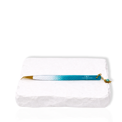 Blue gradient angled eyelash extension tweezer with decorative charm displayed on a white stone surface.