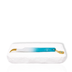 Blue gradient curved eyelash extension tweezer with gold curved tip and evil eye charm displayed on a white stone surface.