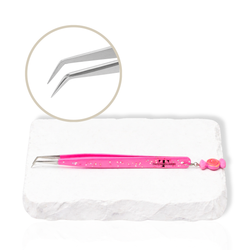 Close-up of Candy Charm Collection tweezer tip showing angled lash tweezer design on a white stone surface.