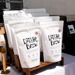Date Brew coffee bags displayed on a table at the event.