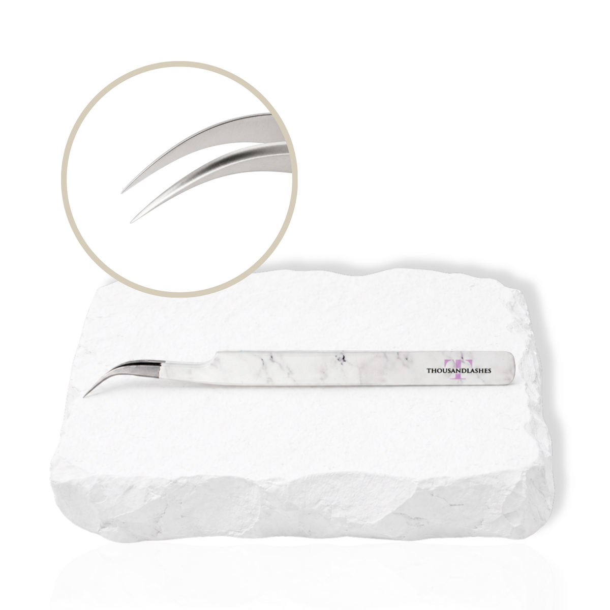 Dolphin curved lash tweezer with angled tip displayed on a white stone background