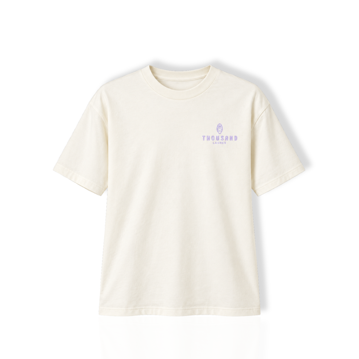 Front view of a white Thousand Lashes lash artist t-shirt displayed on a plain background with a small purple chest logo.