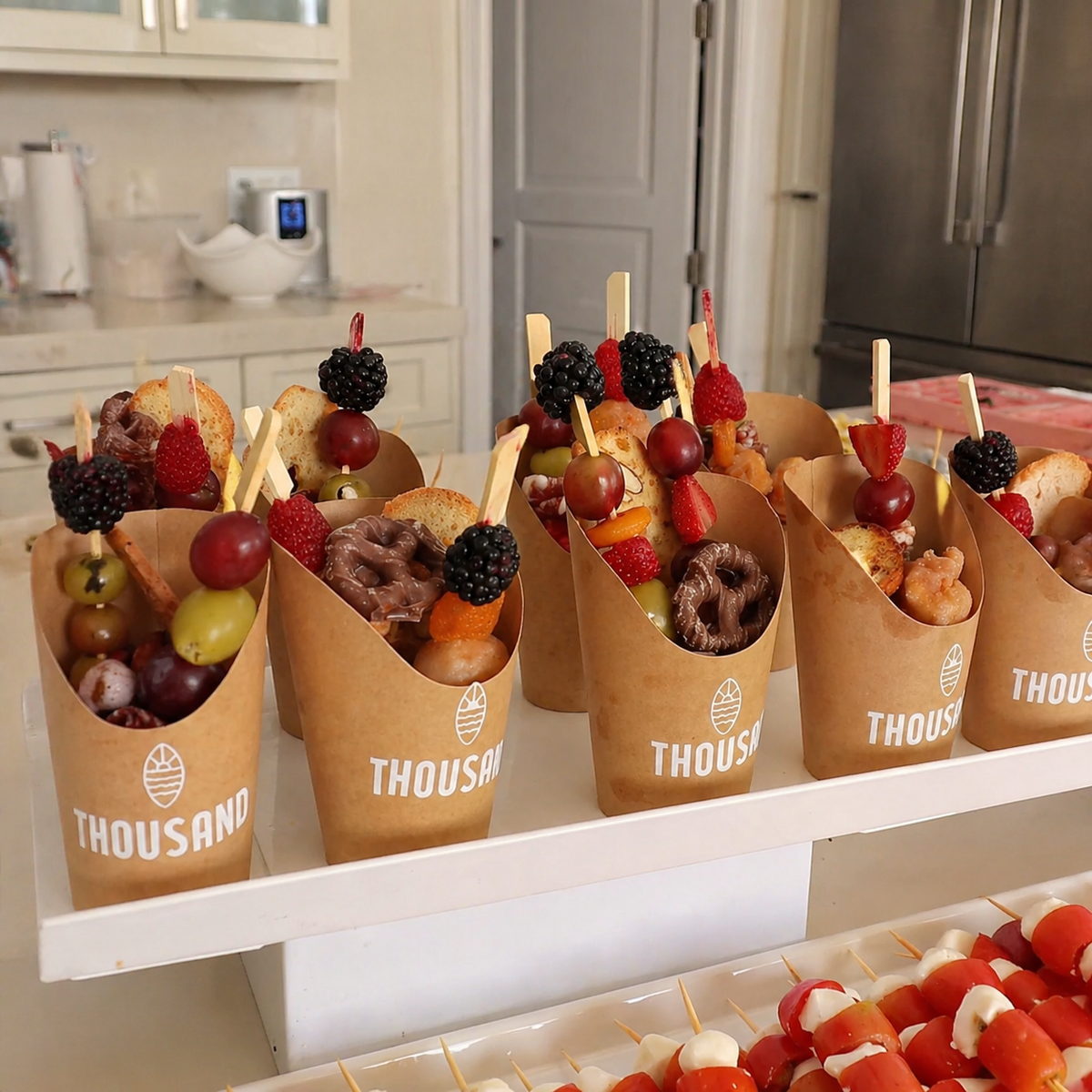 Fruit cups and snack cups prepared for guests at an outdoor wellness event.