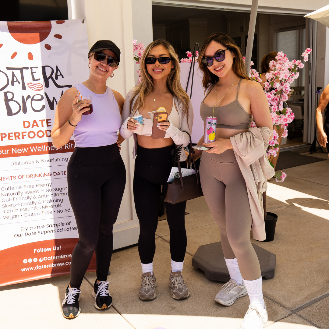 Lash artists posing together with Date Brew products during the event.