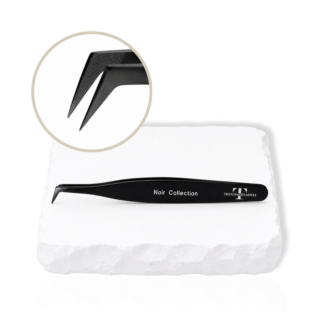Noir Collection black lash tweezer displayed with close-up of sharp tweezer tips on a white stone surface.