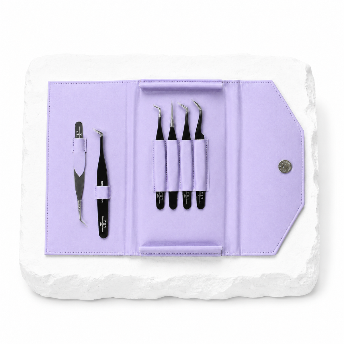 Noir Collection lash tweezer kit displayed in a purple storage case with multiple black tweezers.