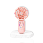 Pink portable lash fan with rhinestone detailing displayed on a white stone surface.