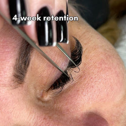 Professional lash artist applying eyelash extensions using ThousandLashes Ultra Crystal Clear Bond adhesive for lash retention
