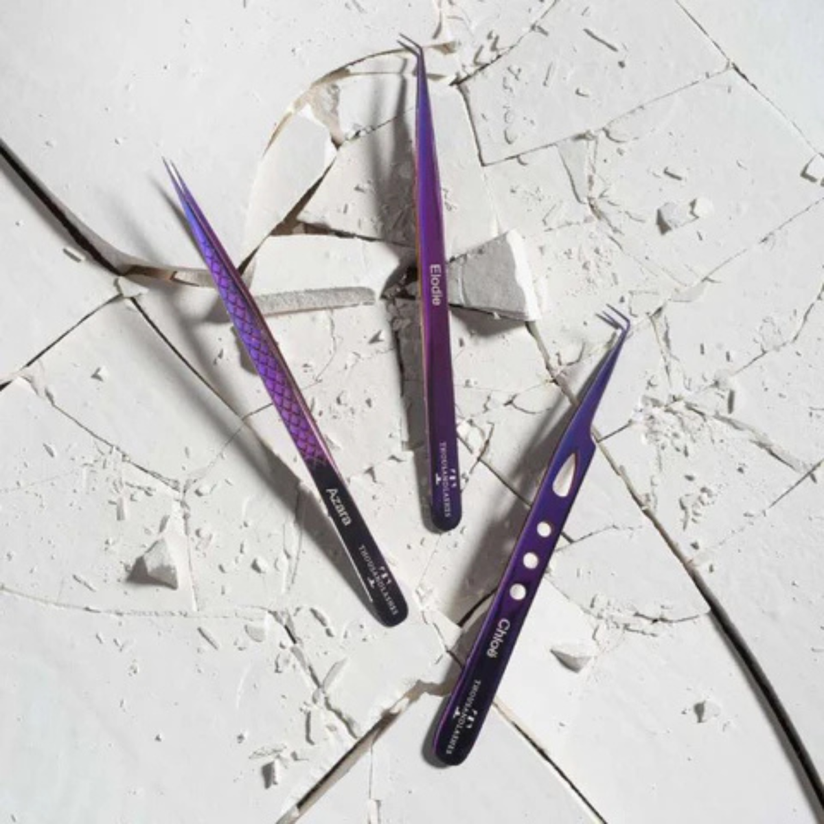 Purple eyelash extension tweezers displayed on a marble surface, showing different tweezer tips and designs for precision lash application.