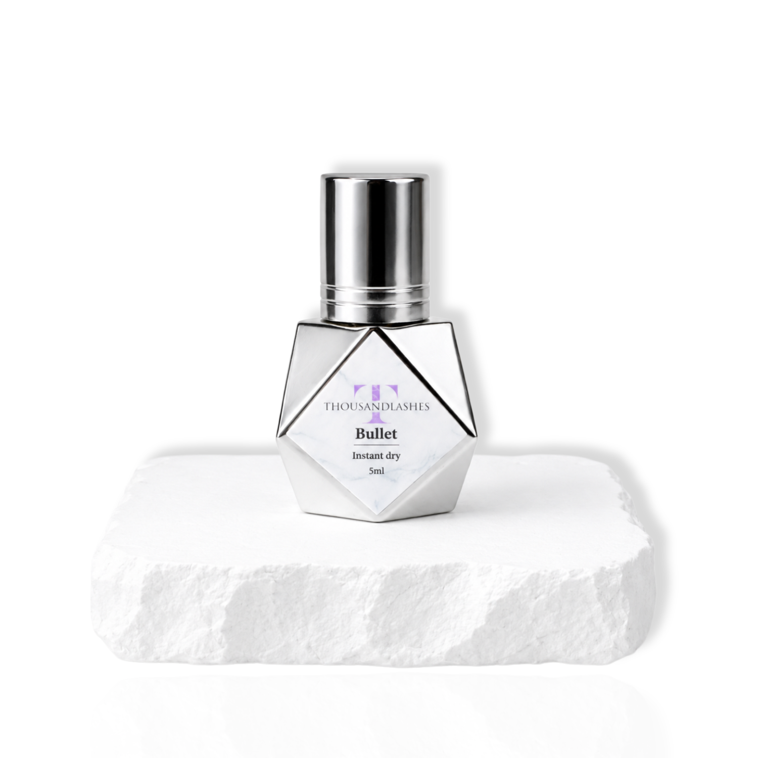 ThousandLashes Bullet instant dry eyelash extension glue bottle with silver cap on white pedestal for professional lash artists