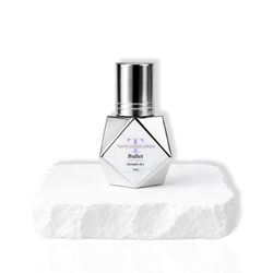 ThousandLashes Bullet instant dry eyelash extension glue bottle with silver cap on white pedestal for professional lash artists