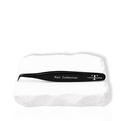 Thousandlashes Noir Collection tweezer on a white stone surface.