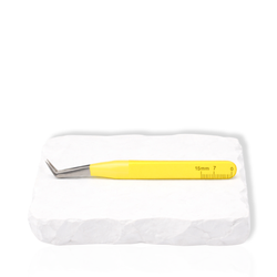 Thousandlashes yellow Summer Spring Collection angled lash tweezer shown from the reverse side on a white stone surface.