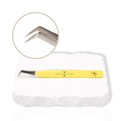 Thousandlashes yellow Summer Spring Collection angled lash tweezer with close-up view of the silver tip.