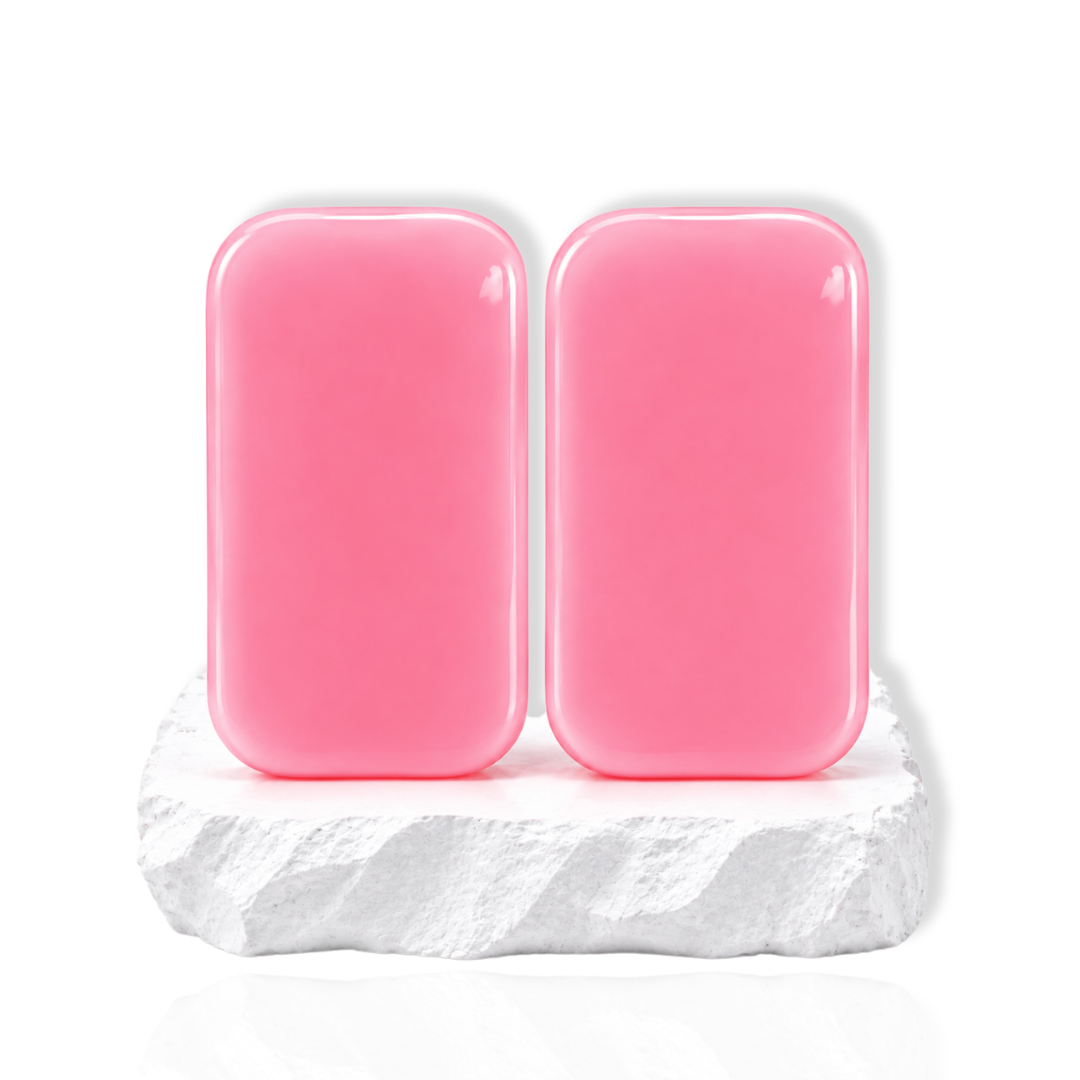Two pink silicone eyelash holder pads displayed on a white stone surface.