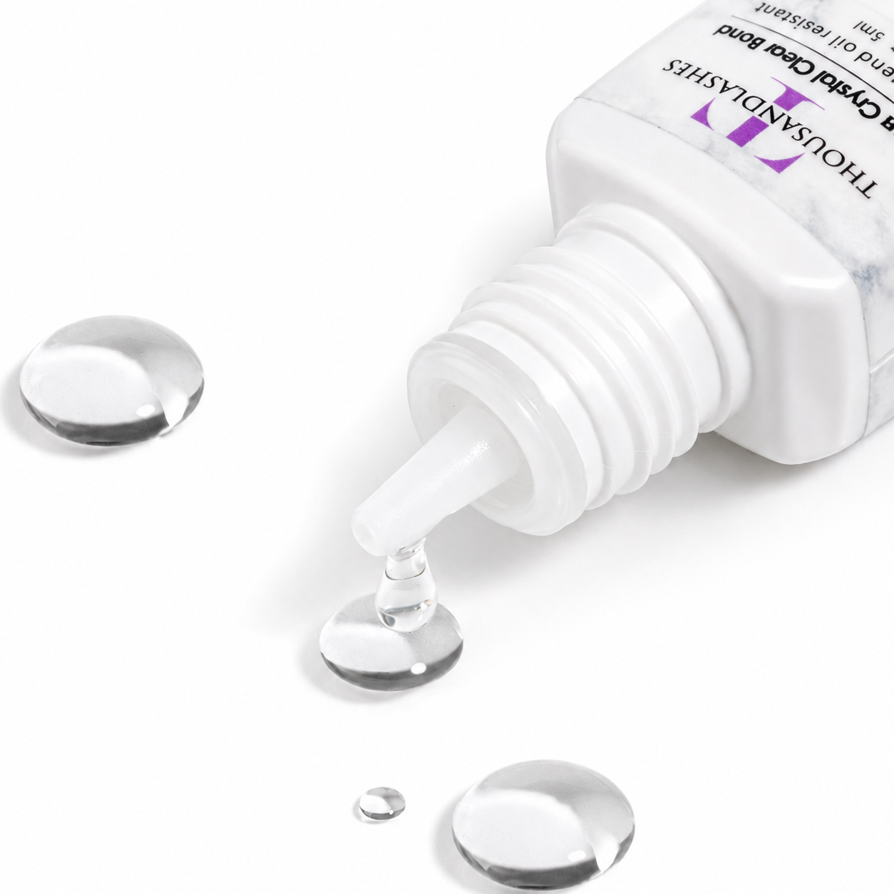 Ultra Crystal Clear Bond clear lash extension adhesive drop showing transparent formula for colored lash extensions