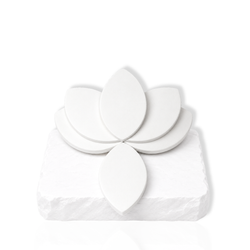 White leaf-shaped makeup sponges arranged on a white stone slab.