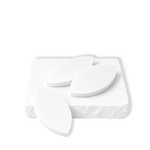 Three white leaf-shaped makeup sponges displayed on a white stone slab.